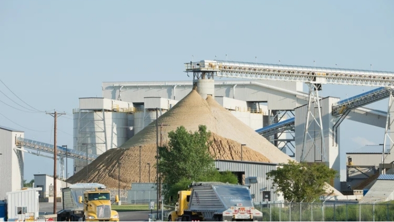 Frac sand storage pile at an industrial processing facility